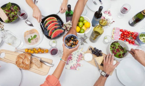 overhead view of friends enjoying garden party lunch on patio table - food stock pictures, royalty-free photos & images