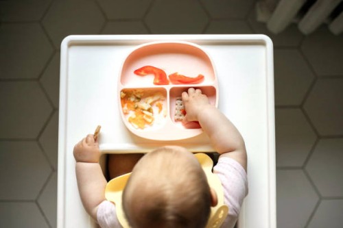 overhead view of infant baby eating in the table for feeding. - food stock pictures, royalty-free photos & images