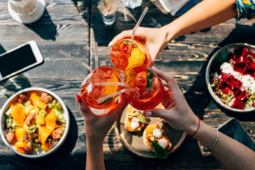 overhead view of three women making a celebratory toast with spritz cocktails - food stock pictures, royalty-free photos & images