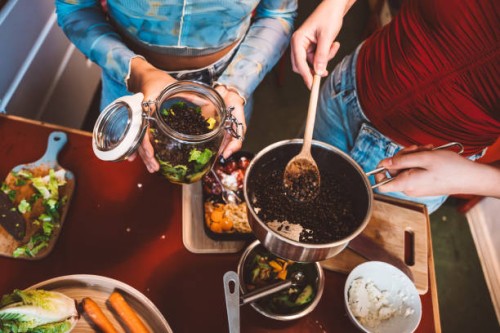 overhead view on female hands filling lentils in mason jar for take away - junk food stock pictures, royalty-free photos & images