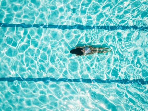 overhead view on girl idiving in swimming pool - fashion stock pictures, royalty-free photos & images