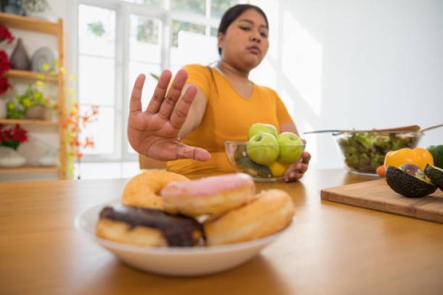 overweight woman refusing unhealthy food. - food stock pictures, royalty-free photos & images