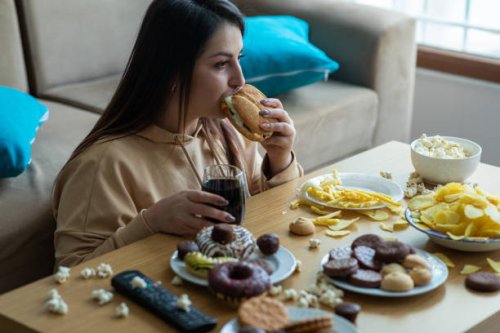 overweight young woman eating junk food - junk food stock pictures, royalty-free photos & images