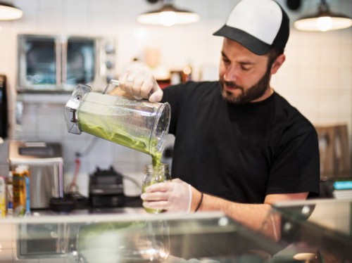 owner working in zero waste oriented grocery and take out food store. - junk food stock pictures, royalty-free photos & images