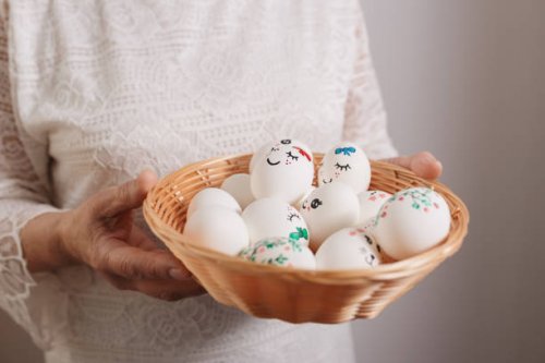 painted easter eggs in wicker plate in hands of older woman - nails art stock pictures, royalty-free photos & images