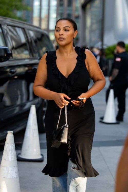 Paloma Elsesser wears black dress outside Michael Kors during New York Fashion Week on September 10, 2024 in New York City.