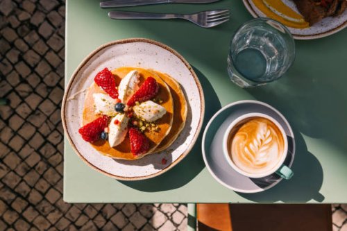 pancakes with strawberry served with latte for breakfast at the cafe - food stock pictures, royalty-free photos & images