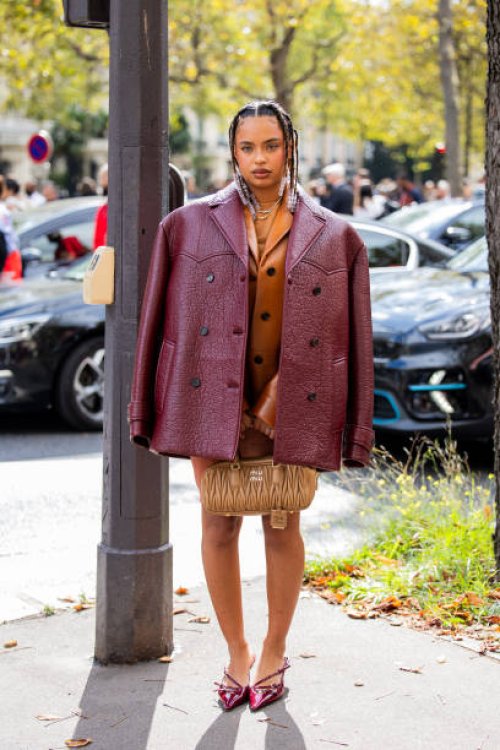 Paola Lacatelli wears burgundy jacket, brown bag, skirt, jacket outside Miu Miu during the Womenswear Spring/Summer 2024 as part of Paris Fashion...