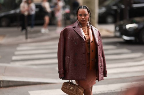 Paola Locatelli is seen wearing a cognac leather jacket, a red-brown oversized leather jacket, an orange dress and a brown Arcadie Miu Miu handbag...