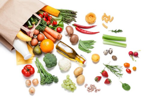 paper bag full of different food on white background - food stock pictures, royalty-free photos & images