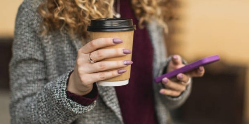 paper cup and mobile phone in hand - junk food stock pictures, royalty-free photos & images