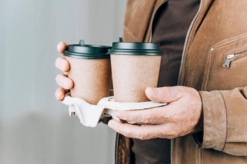 paper cup with coffee in man's hands. - junk food stock pictures, royalty-free photos & images