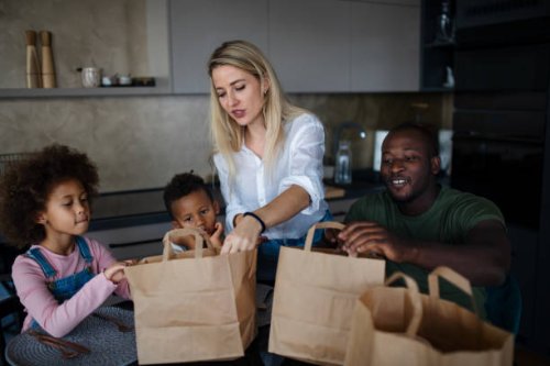 parents bringing take away food and serving at table to little children at home. - junk food stock pictures, royalty-free photos & images