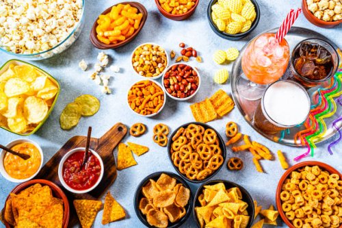 party table with salty snacks and drinks shot from above - junk food stock pictures, royalty-free photos & images
