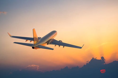 passenger airplane flying above clouds during sunset - travel stock pictures, royalty-free photos & images