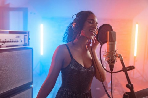 passionate young adult black female singing in a beautiful recording studio - concert stock pictures, royalty-free photos & images