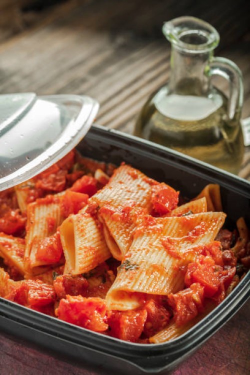 pasta in tomato sauce in plastic container - junk food stock pictures, royalty-free photos & images