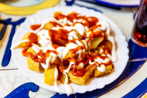 patatas bravas served in a tapas bar, close-up, barcelona, spain - junk food stock pictures, royalty-free photos & images