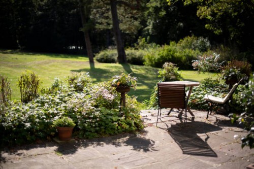 patio with a table and two chairs with cushions - garden decoration photos et images de collection