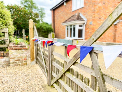 patriotic bunting on gate - garden decoration stock pictures, royalty-free photos & images