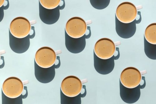 pattern made of cup of cappuccino on blue background - coffee stock pictures, royalty-free photos & images