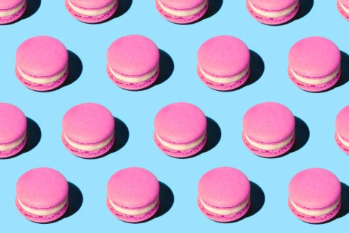 pattern made of tasty pink purple color macaroons on pastel blue background. - food stock pictures, royalty-free photos & images