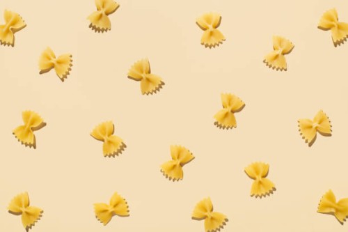 pattern made of uncooked pasta on beige background with shadows. top view, flat lay - food stock pictures, royalty-free photos & images