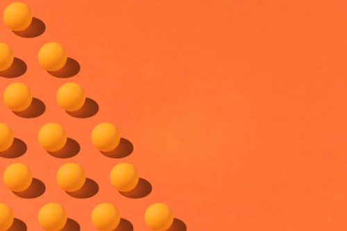pattern of orange ping pong balls with hard shadow on the left side, with copy space on the right. on orange background. group, design and futuristic concept - fashion stock pictures, royalty-free photos & images