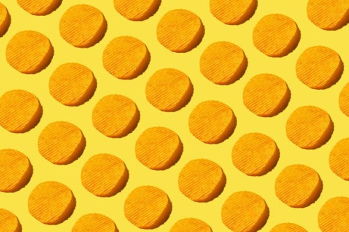 pattern of potato chips on yellow background. flat lay, top view - junk food stock pictures, royalty-free photos & images