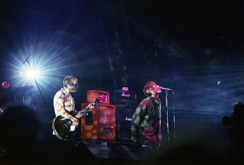 Paul 'Bonehead' Arthurs and Liam Gallagher of Oasis perform on stage at the Glastonbury Festival on June 23th, 1995 in Somerset, England.