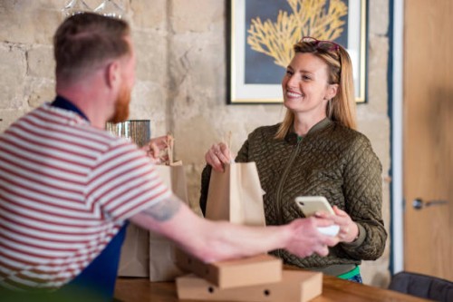 paying for her food order - junk food stock pictures, royalty-free photos & images