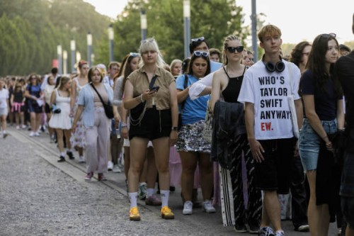 People are seen standing in a line at the entrance to the stadium before the start of the first concert of Taylor Swift's Eras Tour. American singer...