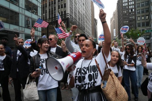People cheer as they march in the "Fashion For Our Future" rally to raise awareness about the importance of voting in the upcoming election, during...