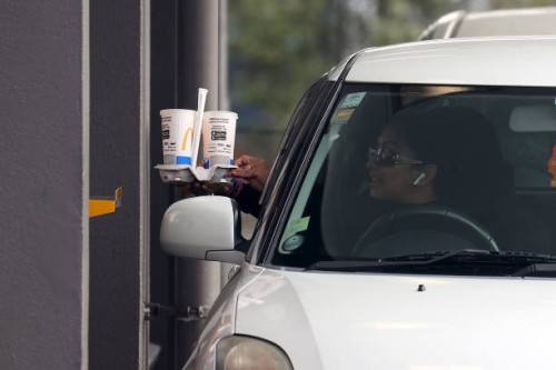 People collect their takeaways from the McDonalds drive-through in Manukau City on September 22, 2021 in Auckland, New Zealand. Restrictions have...