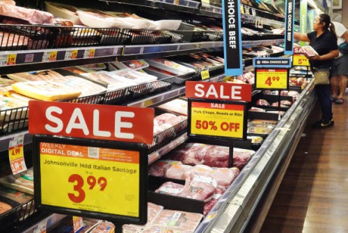 People shop in the meats section of a grocery store as prices are displayed on October 12, 2023 in Los Angeles, California. The Consumer Price Index...