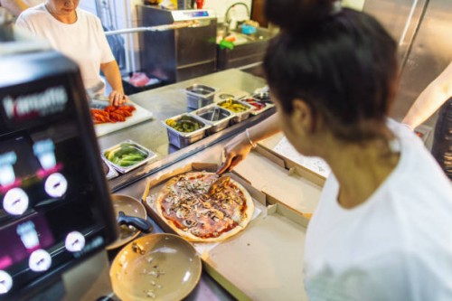 people working in kitchen in fast food restaurant and preparing food for delivery - junk food stock pictures, royalty-free photos & images