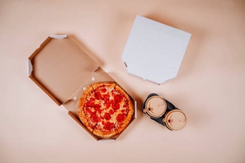 pepperoni pizza near coffee cups against beige background - junk food stock pictures, royalty-free photos & images