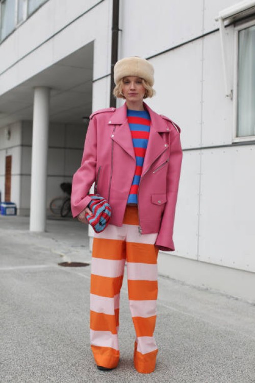 Pernille Rosenkilde is seen wearing a Pink Leather Bikers Jacket with a Multi Coloured Striped Ensemble outside Marimekko show during the Copenhagen...