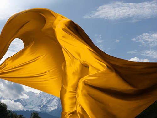 person covered in yellow material with mountains - fashion stock pictures, royalty-free photos & images