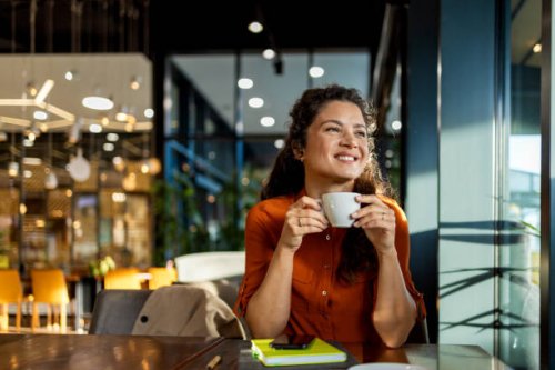 person enjoying coffee in a modern cafe setting. - coffee stockfoto's en -beelden