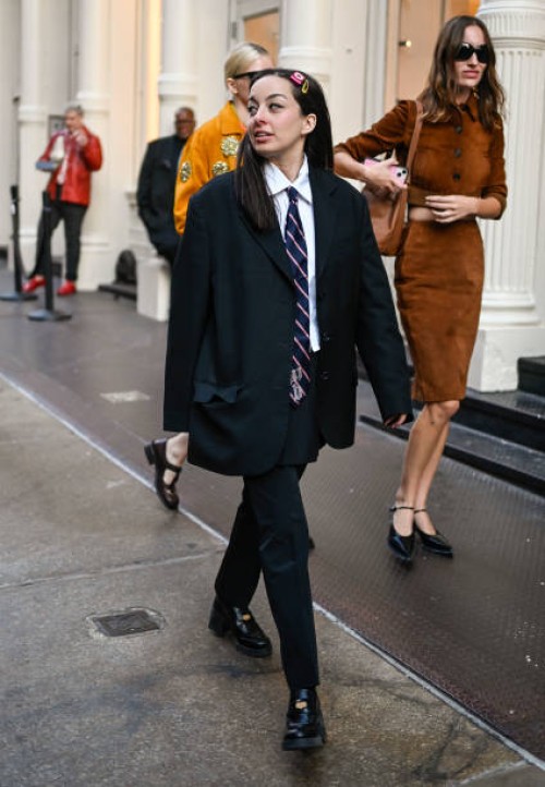 Person is seen wearing a black suit with blue and red striped tie on September 05, 2024 in New York City.