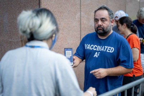 Person presents his proof of vaccination while standing in line for the Foo Fighters show as Madison Square Garden reopens with the first full...