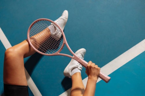 person sitting on a tennis court holding a racquet - fashion stock pictures, royalty-free photos & images
