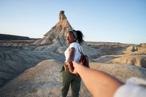 personal perspective of happy black woman guiding her partner to explore a desert, holing hands. - travel stock pictures, royalty-free photos & images