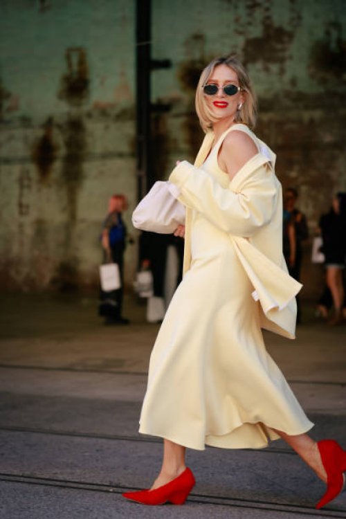 Phoebe Burgess wearing yellow dress ad shirt, red Camilla and Marc shoes and sunglasses during Australian Fashion Week Presented By Pandora 2024 at...
