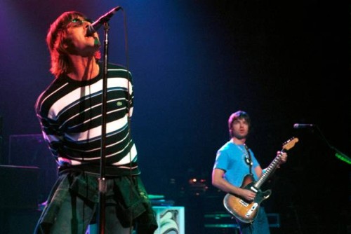 Photo of Liam GALLAGHER and Noel GALLAGHER and OASIS; Noel Gallagher and Liam Gallagher performing live onstage at Ancienne Belgique