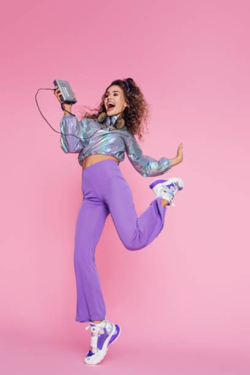 photo of positive girl holding old audio player in her hand and dancing - fashion stock pictures, royalty-free photos & images