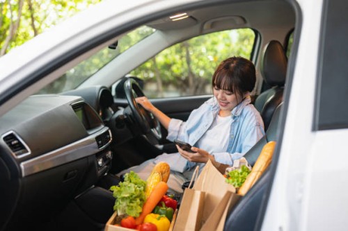 picking up her takeaway lunch in a drive through - junk food stock pictures, royalty-free photos & images