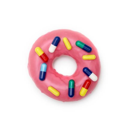 pink doughnut with capsules - junk food stock pictures, royalty-free photos & images