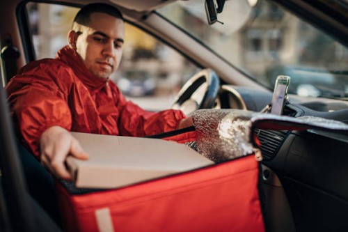 pizza delivery man in a car - junk food stock pictures, royalty-free photos & images